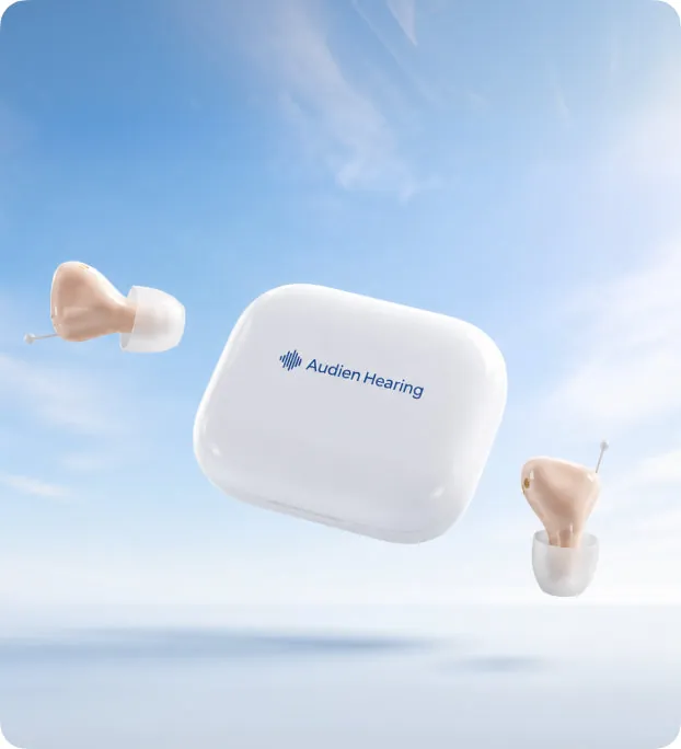Atom Air earpieces and charging case floating against a blue sky