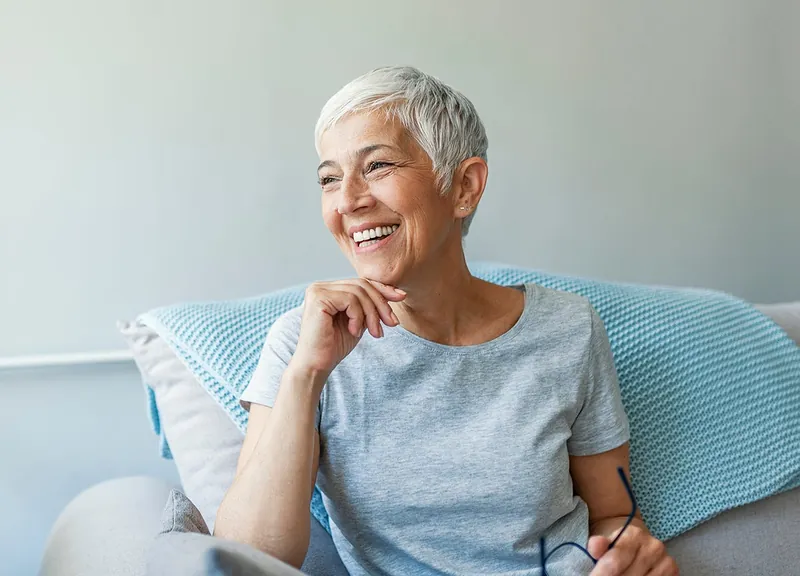 Smiling woman relaxing on a sofa